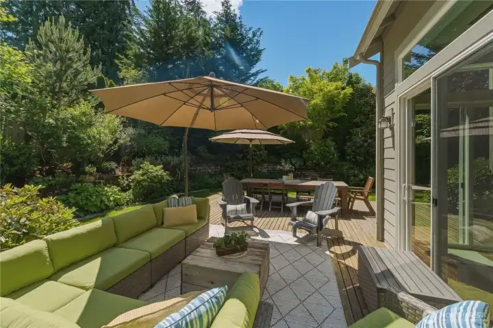 Right off the breakfast nook, the spacious cedar deck invites effortless outdoor living — plenty of room for a large seating area, a 10-person dining table, and your barbecue for summer gatherings