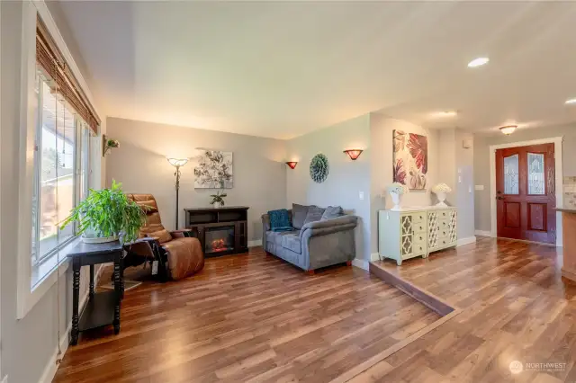 Front room area with electric fireplace that stays with the home.