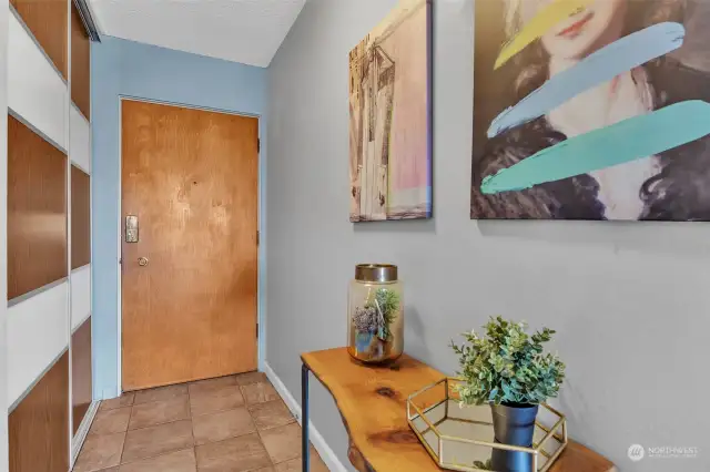 Entryway to the unit with large coat closet.