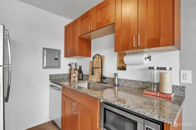 Cherry cabinets in the kitchen with granite countertops.