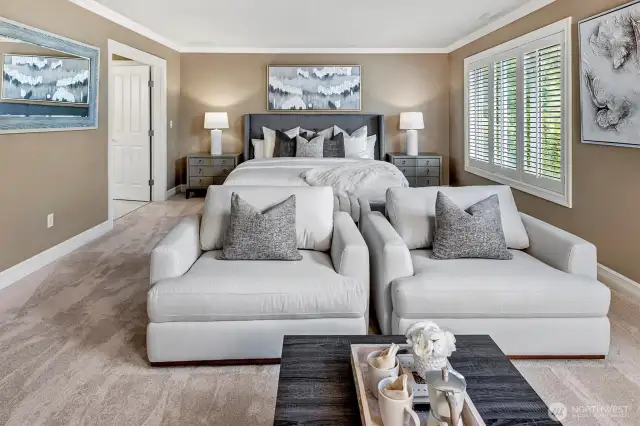 This epic primary bedroom is connected to the en-suite through double doors.