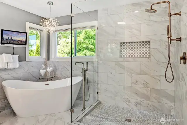 Custom glass shower and free standing tub combined with high end fixtures makes this bathroom feel like a spa.