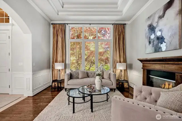 Gleaming hardwoods and tray ceilings add sophistication  in the living room