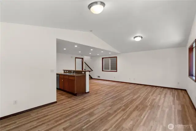Spacious living room features beautiful new light-toned laminate flooring, creating a warm and inviting atmosphere.