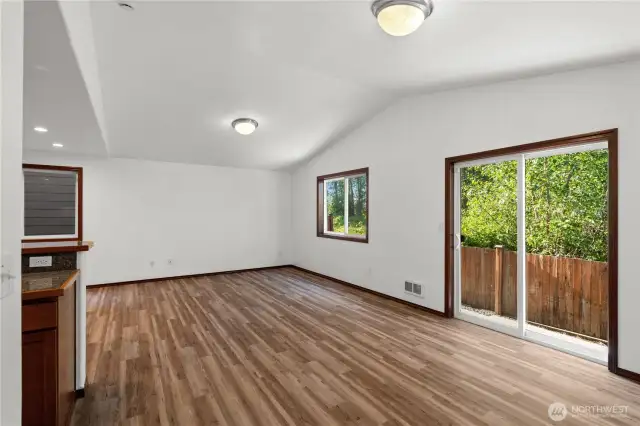 Another view of the living room, where the sliding door provides seamless access to the backyard and invites in plenty of natural light.