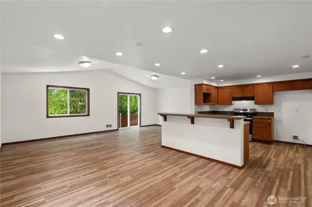 Expansive view of the downstairs living space showcasing the fresh new interior paint and versatile layout.
