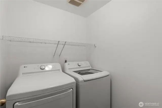 Another view of the laundry room, with extra storage above the washer & dryer to keep things organized and tidy.