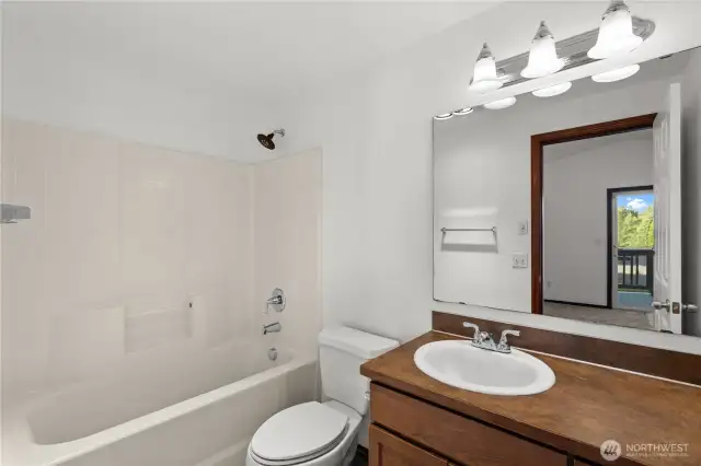 Primary full bathroom with ample storage and counter space.