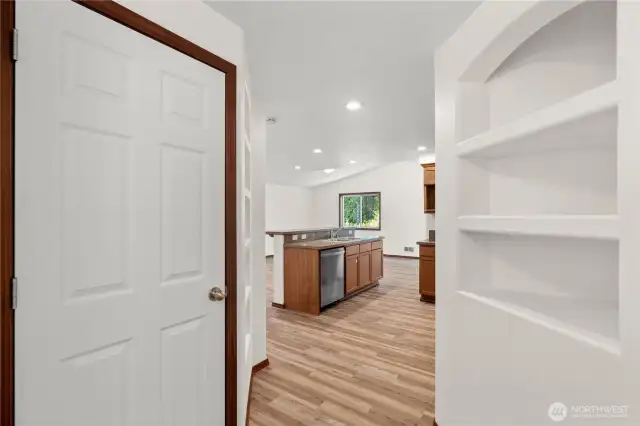Bright and welcoming entryway featuring crisp light tones and built-in shelving, perfect for storage or displaying décor.