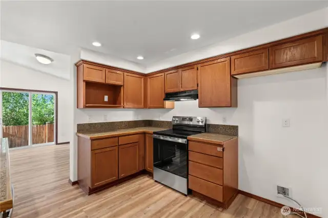 Warm-toned cabinets bring a cozy and inviting feel to the kitchen space.