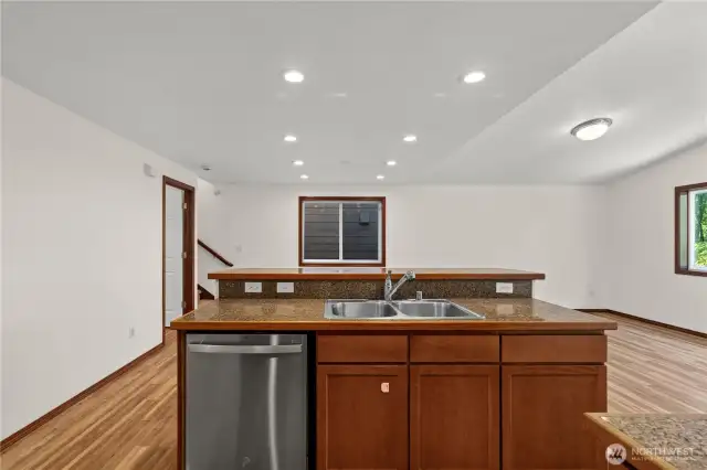 Spacious island features a sink, brand new dishwasher, and plenty of storage—perfect for meal prep and casual gatherings.