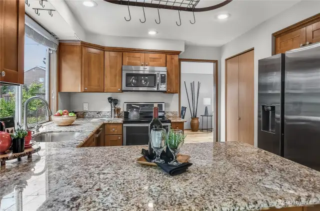 Another look at the kitchen with stainless steel appliances and granite countertops.