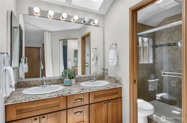 Primary bedroom ensuite bathroom with double sinks.