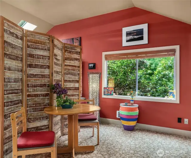 Sweet dining nook in this colorful retreat. This window faces north onto the privacy hedge along the north side of the driveway.