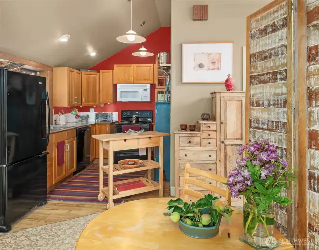 Open floor plan maximizes the space and feels cozy and efficient. Note the vaulted ceilings throughout the main living areas.