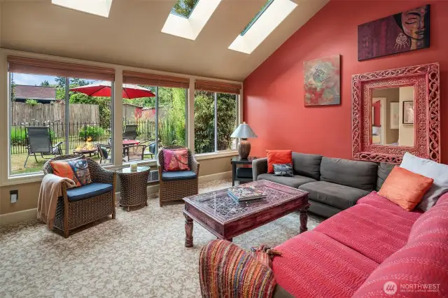 This room is so inviting! Vaulted ceilings, skylights, big windows -- how could you not want to hang out here?