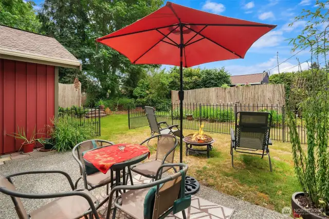 Sweet patio with its own enclosed yard. Hot tub enclosure can be seen to left; DADU is behind the fence.