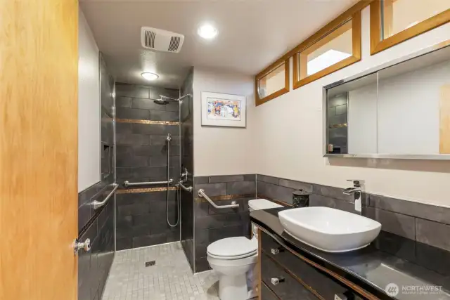Curbless shower with rain-shower head with hand-held shower head option.