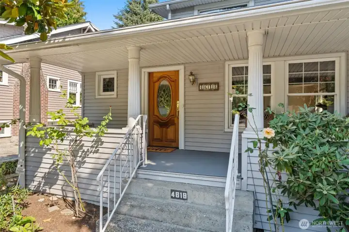 Covered front porch entrance next to private driveway.