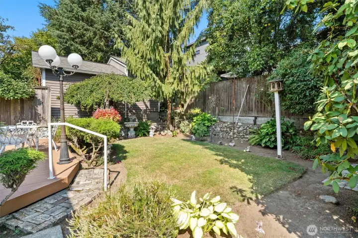 Well-kept back yard, thoughtful plantings.