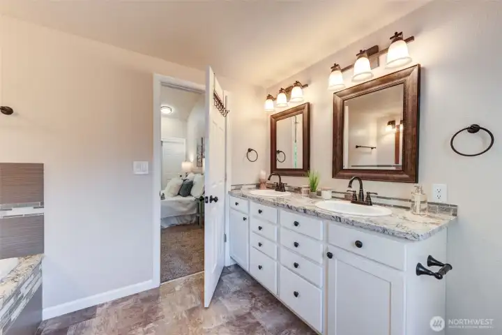 Luxurious 5-piece primary bath with soaking tub, separate shower, dual sinks, and elegant finishes—your own private retreat.