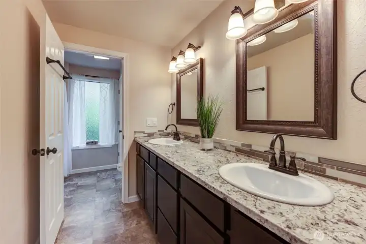 Spacious guest bath with double sinks and a full tub/shower—perfect for busy mornings or overnight guests.