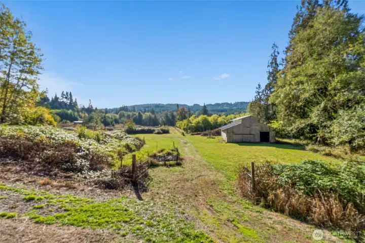 Barn, garden area, orchard, & pond towards the back