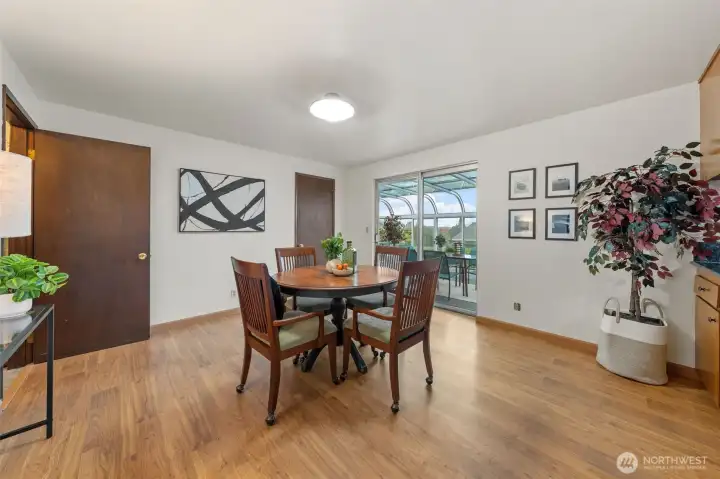 The breakfast room is centrally located between the kitchen and sunroom for a smooth, open layout. Sliding glass doors lead to the sunroom, offering an easy indoor-outdoor connection.
