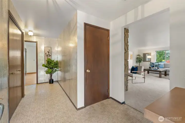 Enter onto an easy-care ceramic tile foyer. Notice the beautiful, soild wood doors here that you will find throughout the home. The door in front leads to the lower-level.