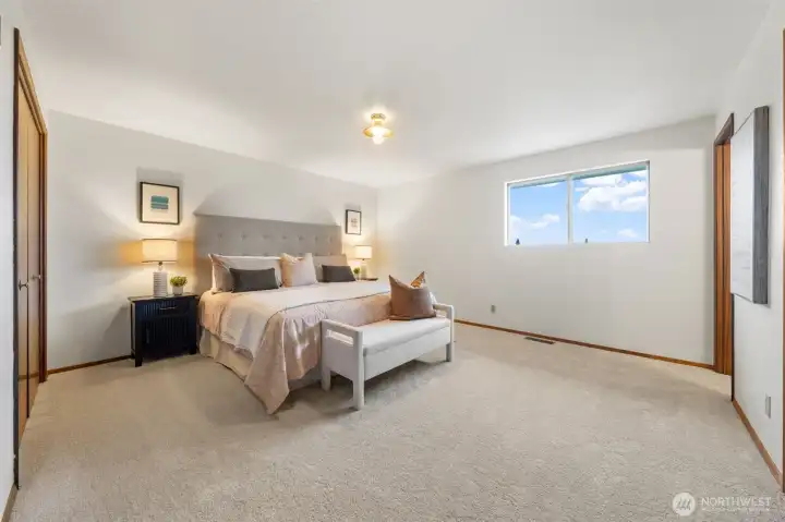 Welcome to the Primary Suite. It features wall-to-wall carpet, fresh paint, and a private bath.