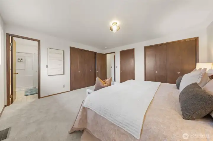 The Primary Suite offers generous dual closet space and fresh carpeting throughout. An updated en-suite bath features a walk-in shower and modern finishes.