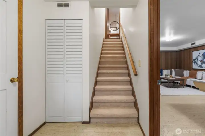 The lower-level entry provides direct access to the garage and storage through the door on the left. To the right, you'll find the family room and hallway leading to two additional bedrooms and a 3/4 bath.
