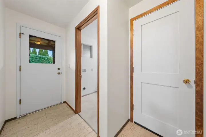 This lower-level hallway offers access to the backyard through a rear entry door. It also connects to the utility room and a separate storage space for added convenience.