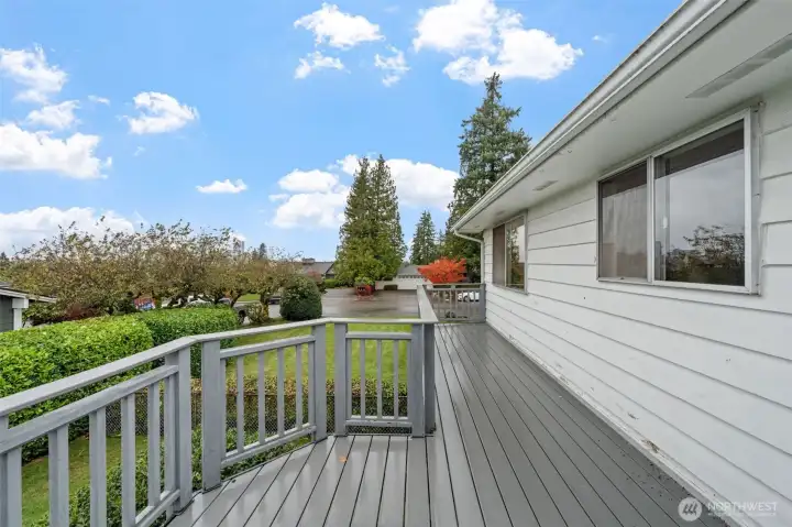 The spacious deck has been updated with low-maintenance composite decking for durability and long-term use. It's an ideal spot for outdoor dining or relaxing while overlooking the landscaped yard.
