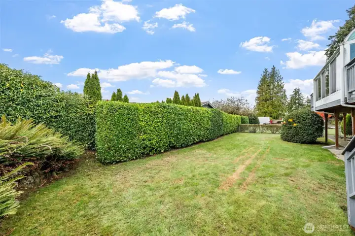 The back yard is fully fenced and beautifully landscaped, providing the perfect space for entertaining or for quiet solitude.