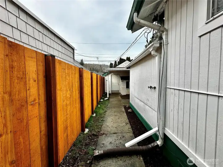 Concrete walkway to back yard