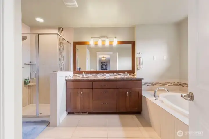 Spa-inspired 5-piece primary bath includes dual sinks, soaking tub, and separate shower. Spacious layout offers both comfort and function, with added touches like TV power and connections for next-level relaxation.