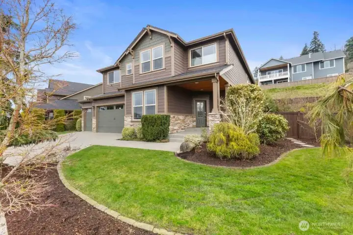 The home features a covered front entrance, keyless entry, and front and back sprinkler systems plus drip hoses throughout backyard beds ensure lush landscaping with ease.