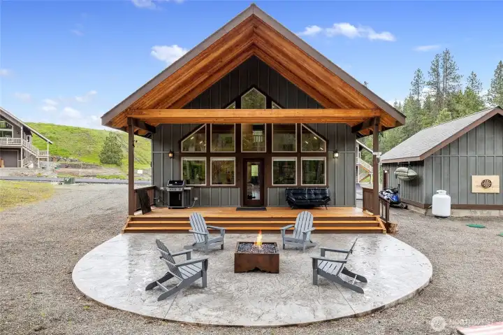 Welcome to 330 Rockberry Loop! Enjoy relaxing evenings around the custom propane fire pit on the spacious patio, or unwind in the hot tub (not pictured) on the covered deck.