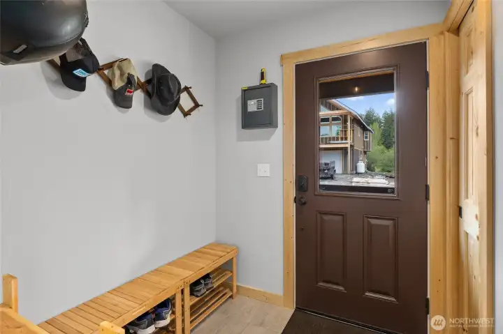 The entryway creates a functional transition, perfect for dropping coats and boots before entering the home.