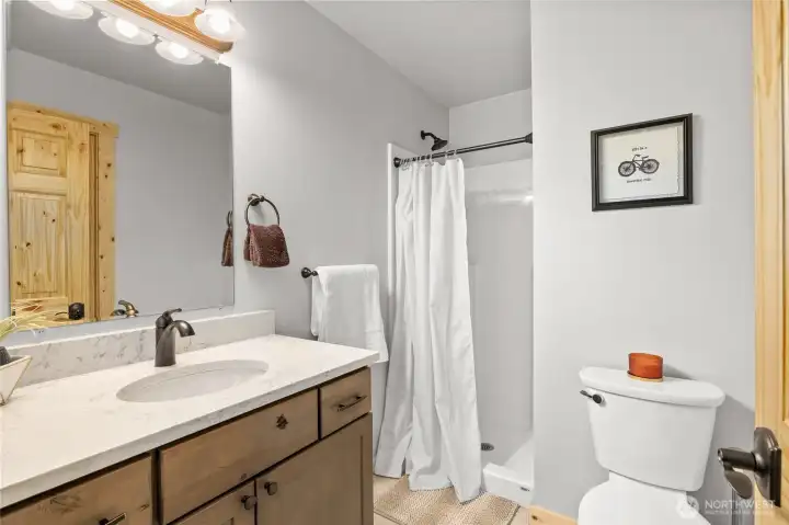 The main floor includes a bathroom with a modern, full-size shower for added convenience.