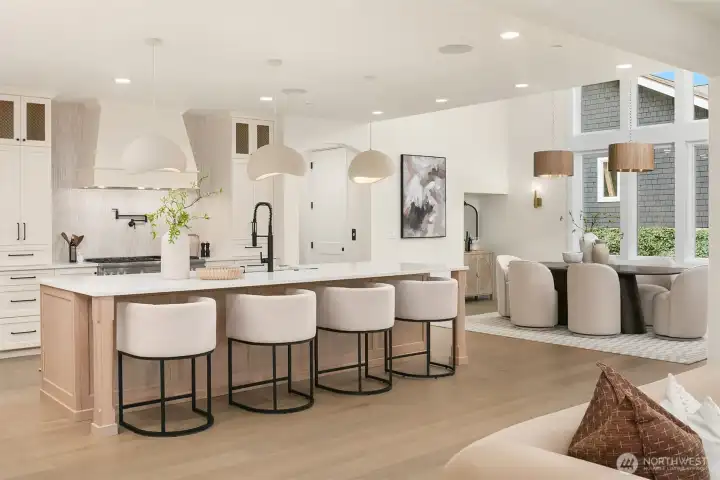 Chef’s kitchen featuring Thermador appliances, expansive island with seating, custom cabinetry, walk-in pantry, and designer pendant lighting, thoughtfully designed for both everyday living and entertaining.