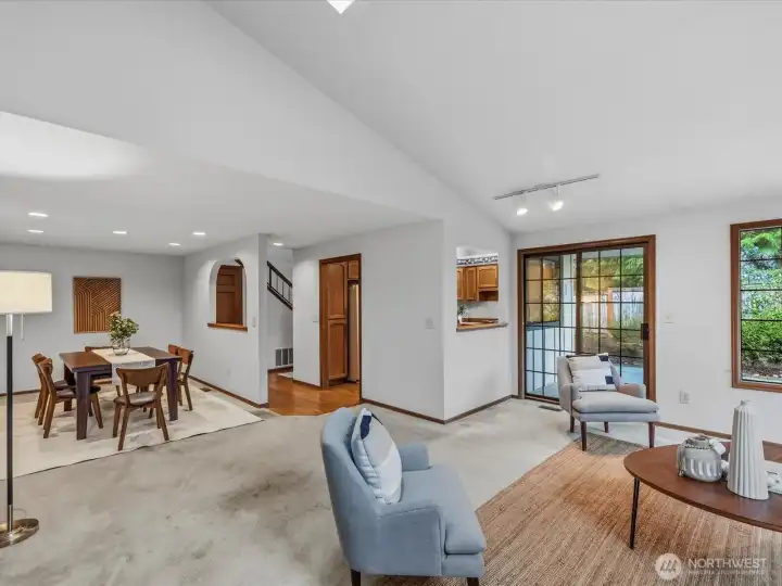 View from living room towards dining room on the left, sliding glass door to the peaceful backyard