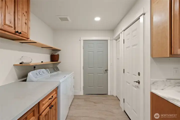 laundry off kitchen. Door to right is for upstairs. door straight ahead is for shop