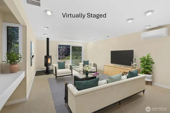 Views meet comfort in the spacious living room, where a mini-split A/C system and propane fireplace keep the climate just right throughout the year.