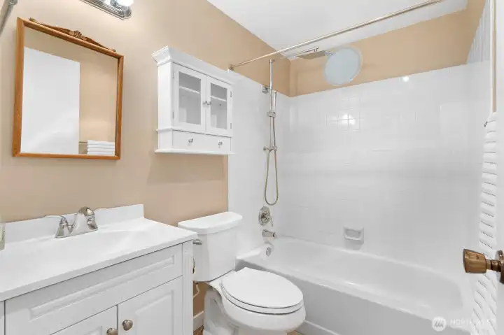 A well-appointed full bath serves the two guest bedrooms on the first living level, offering comfort and convenience for family and visitors alike.