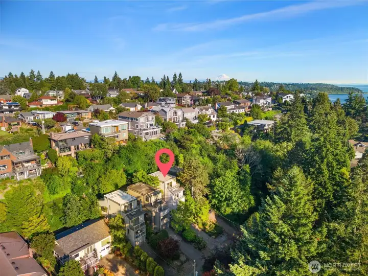 A canopy of mature trees lines this quiet, private street — a serene and secluded setting that somehow still commands gorgeous views of Puget Sound and the Olympic Mountains.