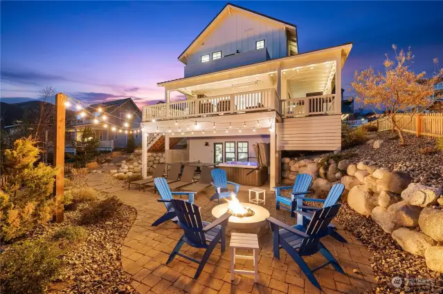 Twilight view of the home's outdoor entertaining area & amenities.