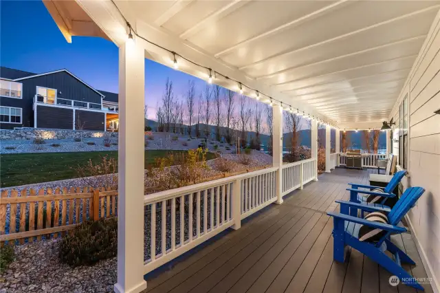 Classic covered wraparound porch overlooking the adjacent park area.