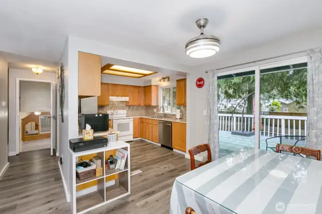 kitchen open to dining with slider to large back deck